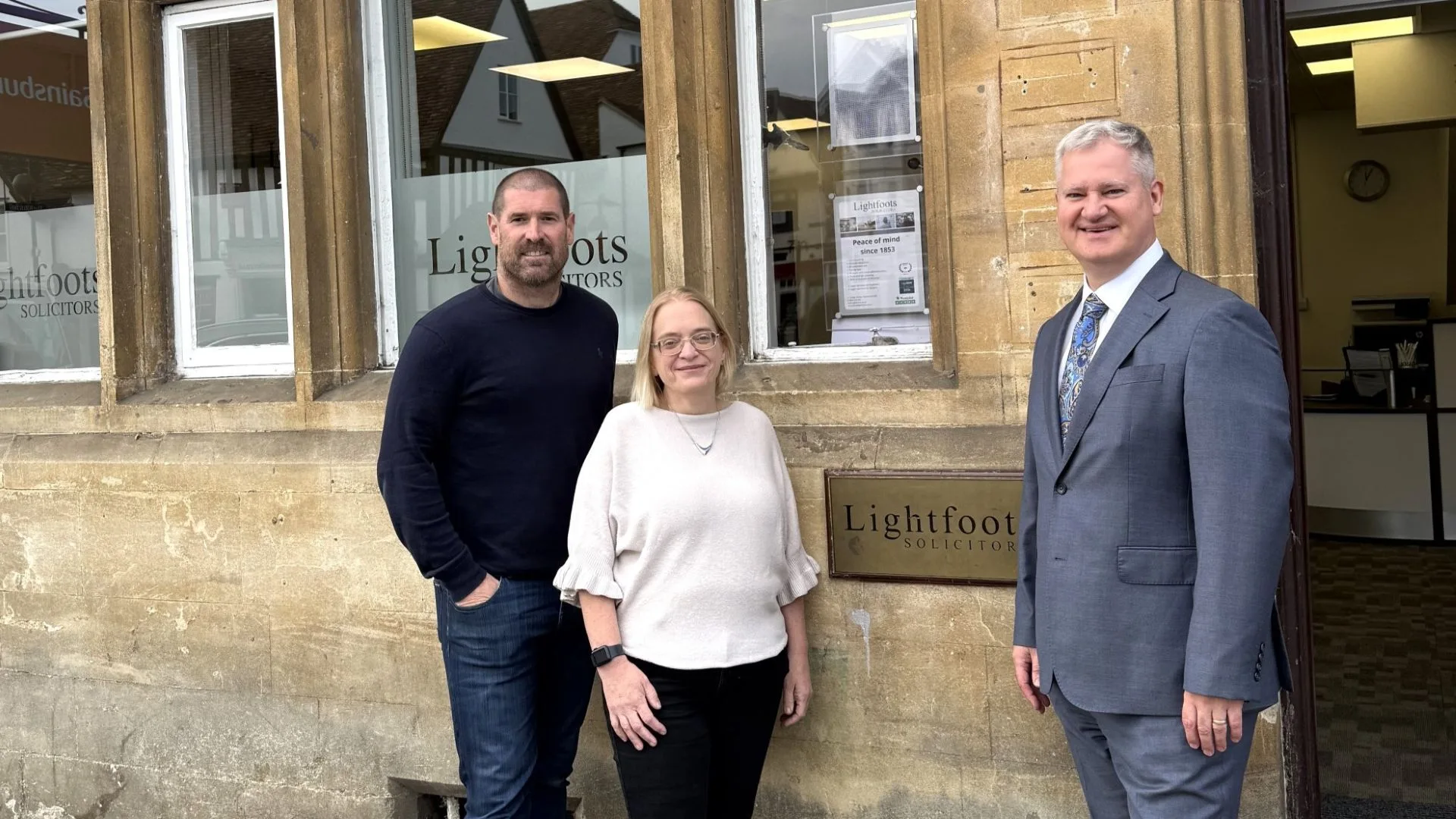 Rachel Stafford, Joe Middleton and Charles Fraser standing outside Lightfoots Solicitors.